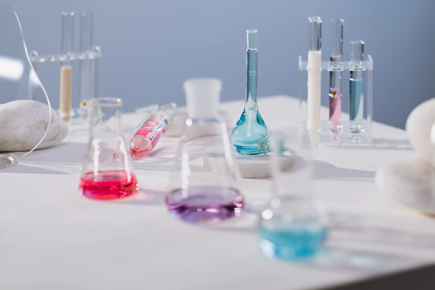 Laboratory glassware with pastel formulations on a light workbench