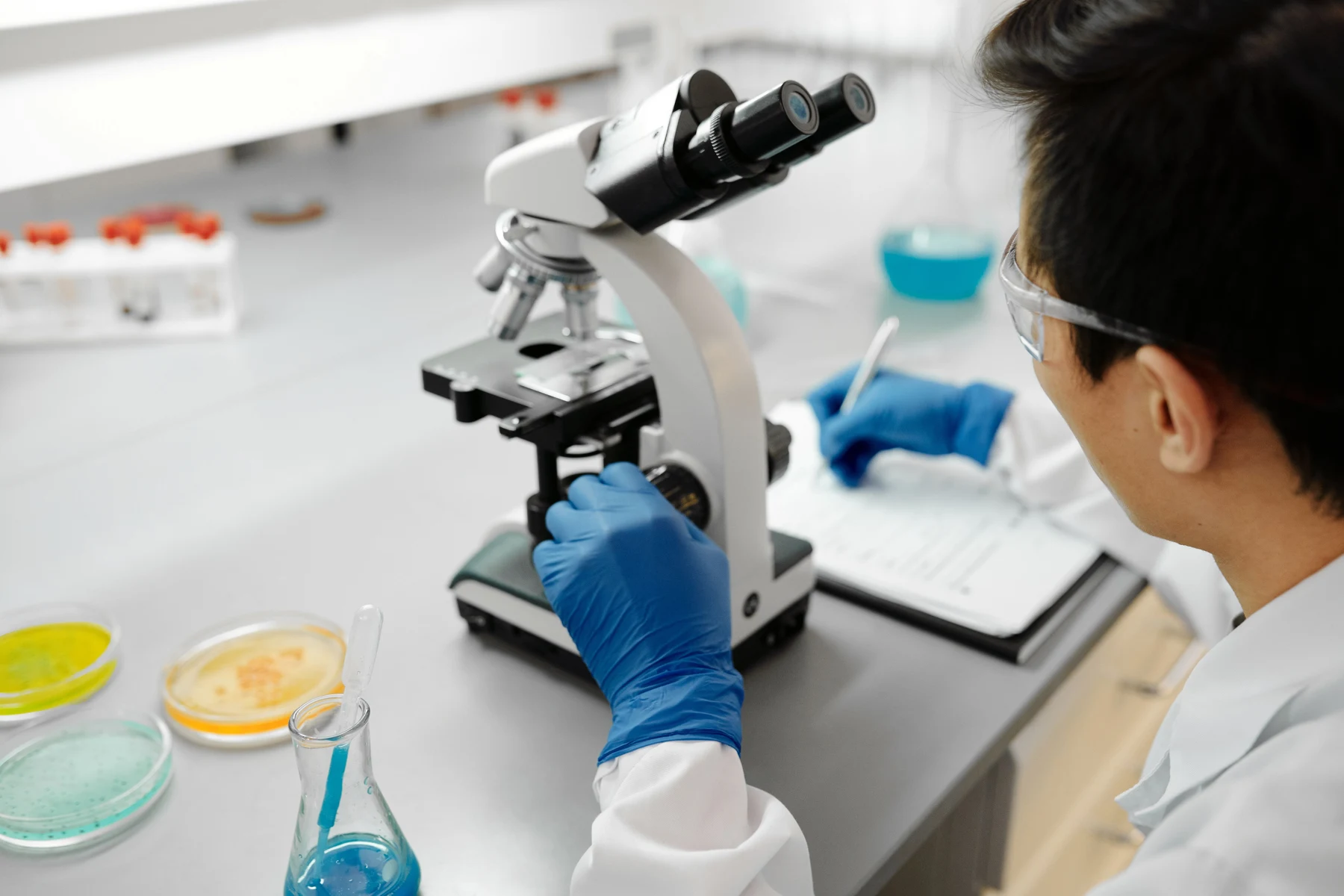 Laboratory researcher examining samples with a microscope